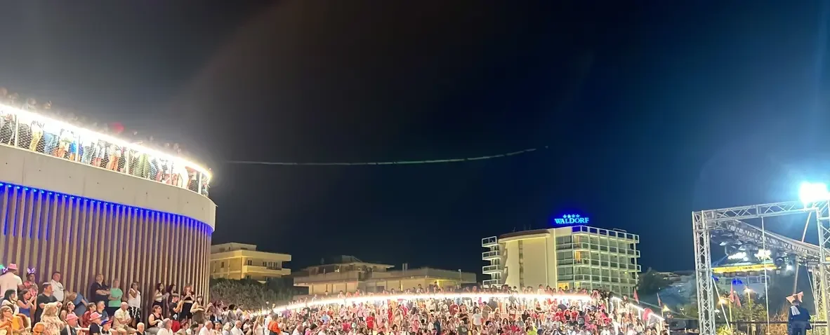 Koncert a riminii strandon a Notte Rosa idején, a közönség a kivilágított színpad előtt